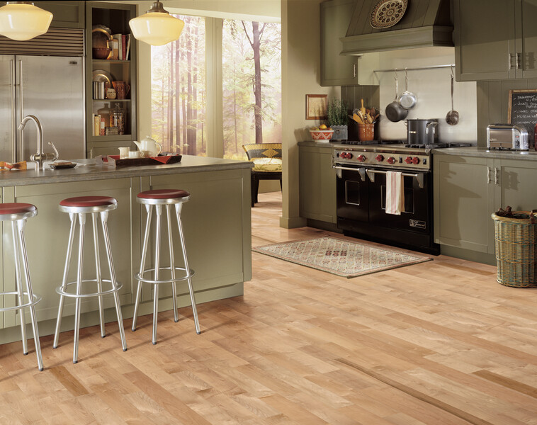 Kitchen with a stove and island featuring engineered hardwood