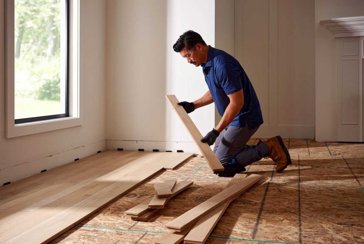 Man installing solid hardwood flooring