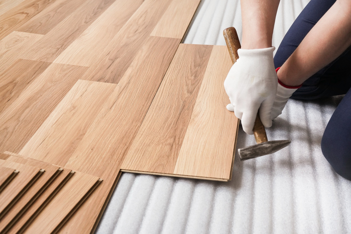 Man and his son installing a floating engineered hardwood floor